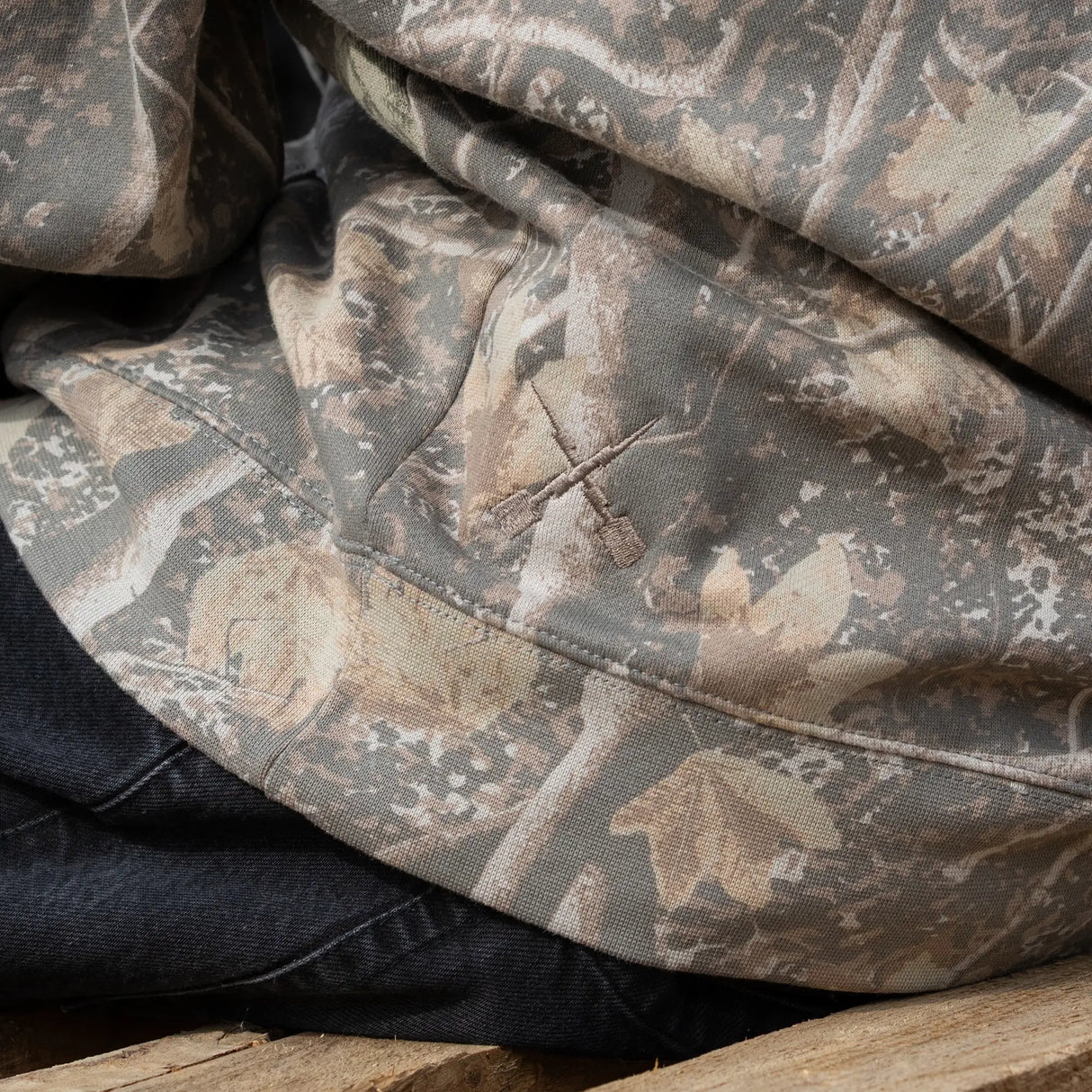 Camouflage hoodie sleeve and kangaroo pocket area with stitched seam details