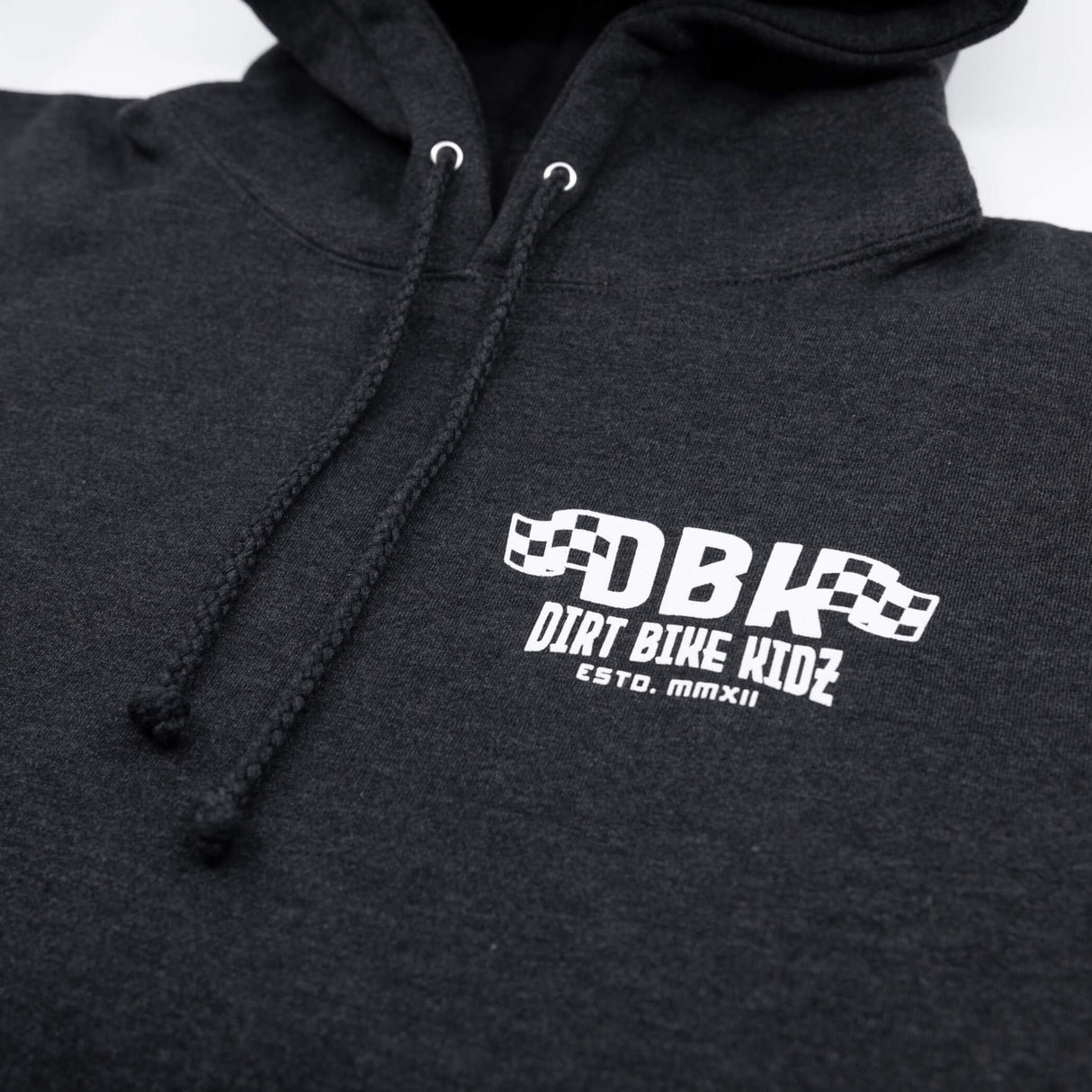 Kids dark hoodie close-up showing hood drawstrings and chest logo graphic
