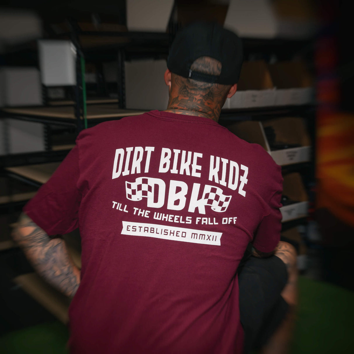 Burgundy T-shirt showing the large back DBK “Till the Wheels Fall Off” graphic