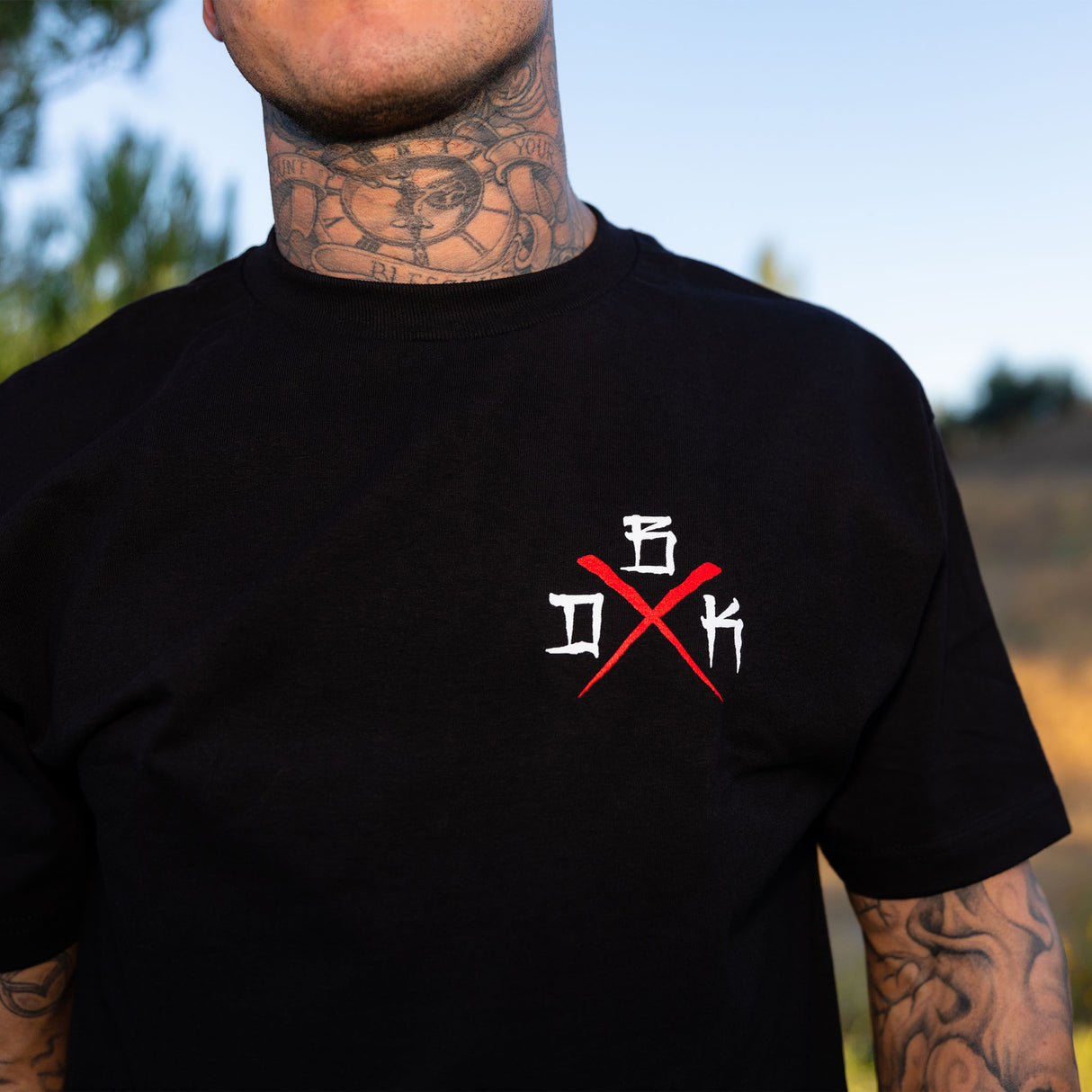 Black T-shirt close-up of small chest graphic in white and red