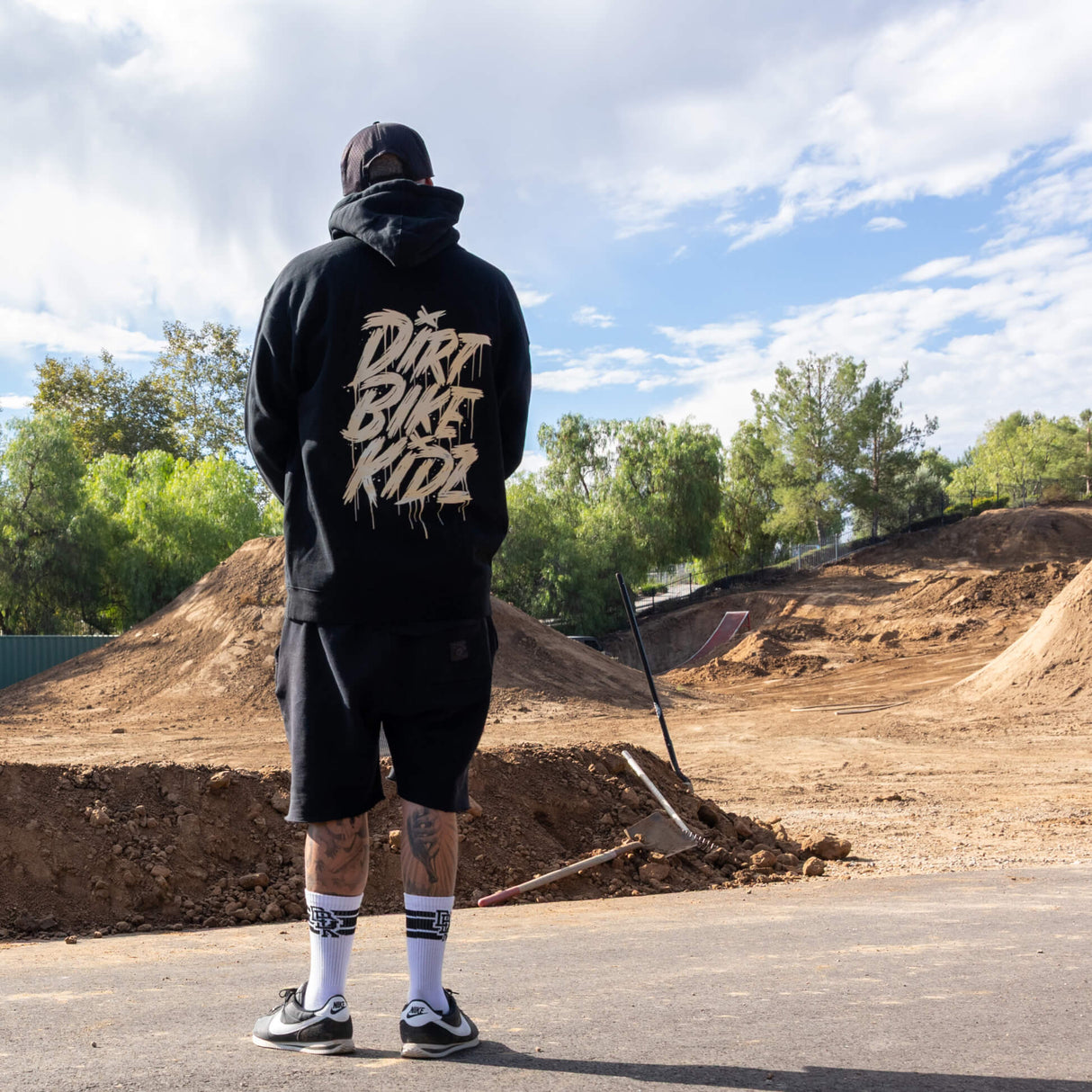 Black hoodie with large gold back graphic, hood up, and drawstrings