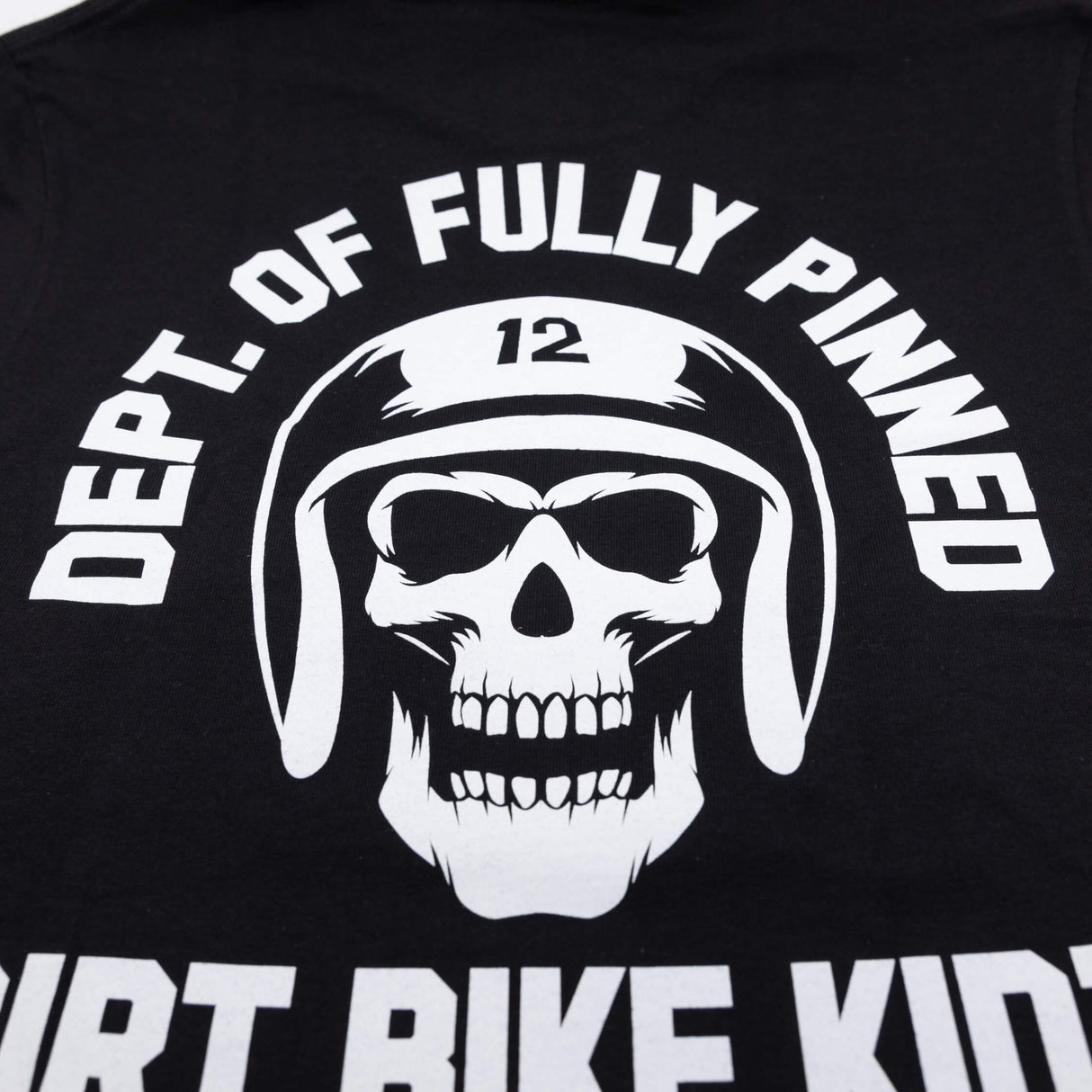 Black kids graphic tee close-up of back skull helmet emblem filling the chest area.