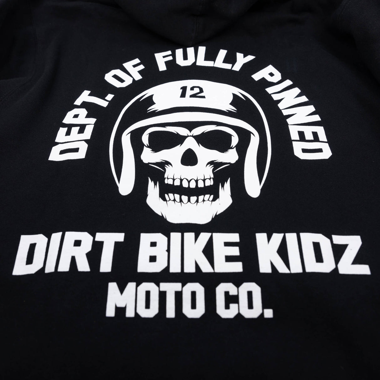 Black hoodie with large back skull logo and bold “DIRT BIKE KIDZ MOTO CO.” text.