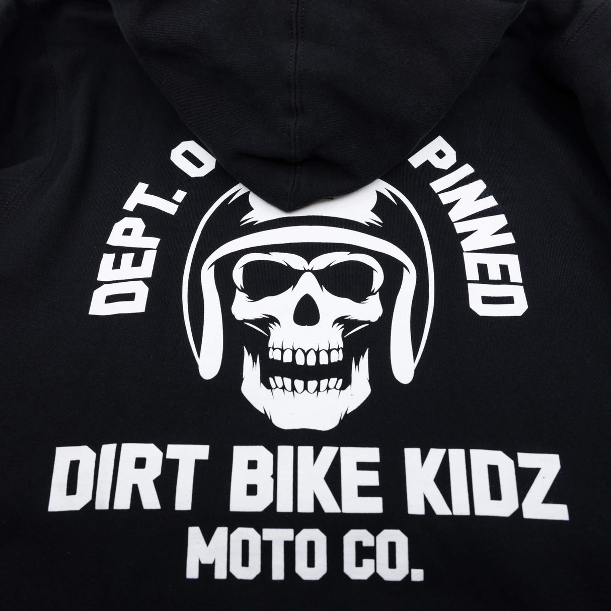 Black hoodie with close-up back skull graphic and “DIRT BIKE KIDZ MOTO CO.” text.