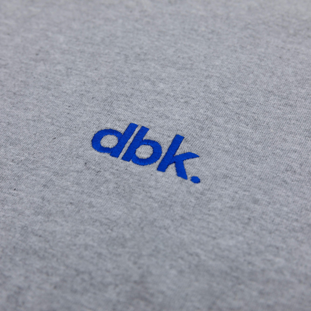 Heather gray crew T-shirt with blue dbk logo close-up