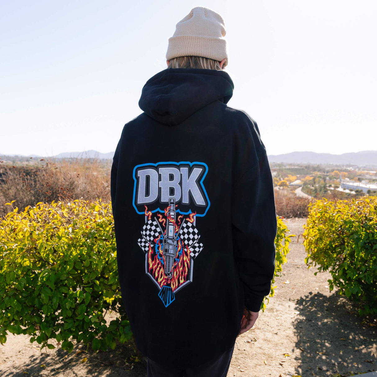 Black wide open hoodie back view with DBK flame logo graphic and drawstring hood