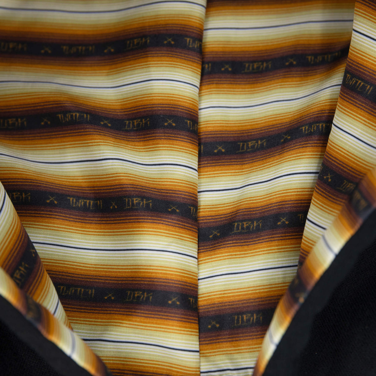 Striped inner hood lining with multicolor bands and navy hoodie edge