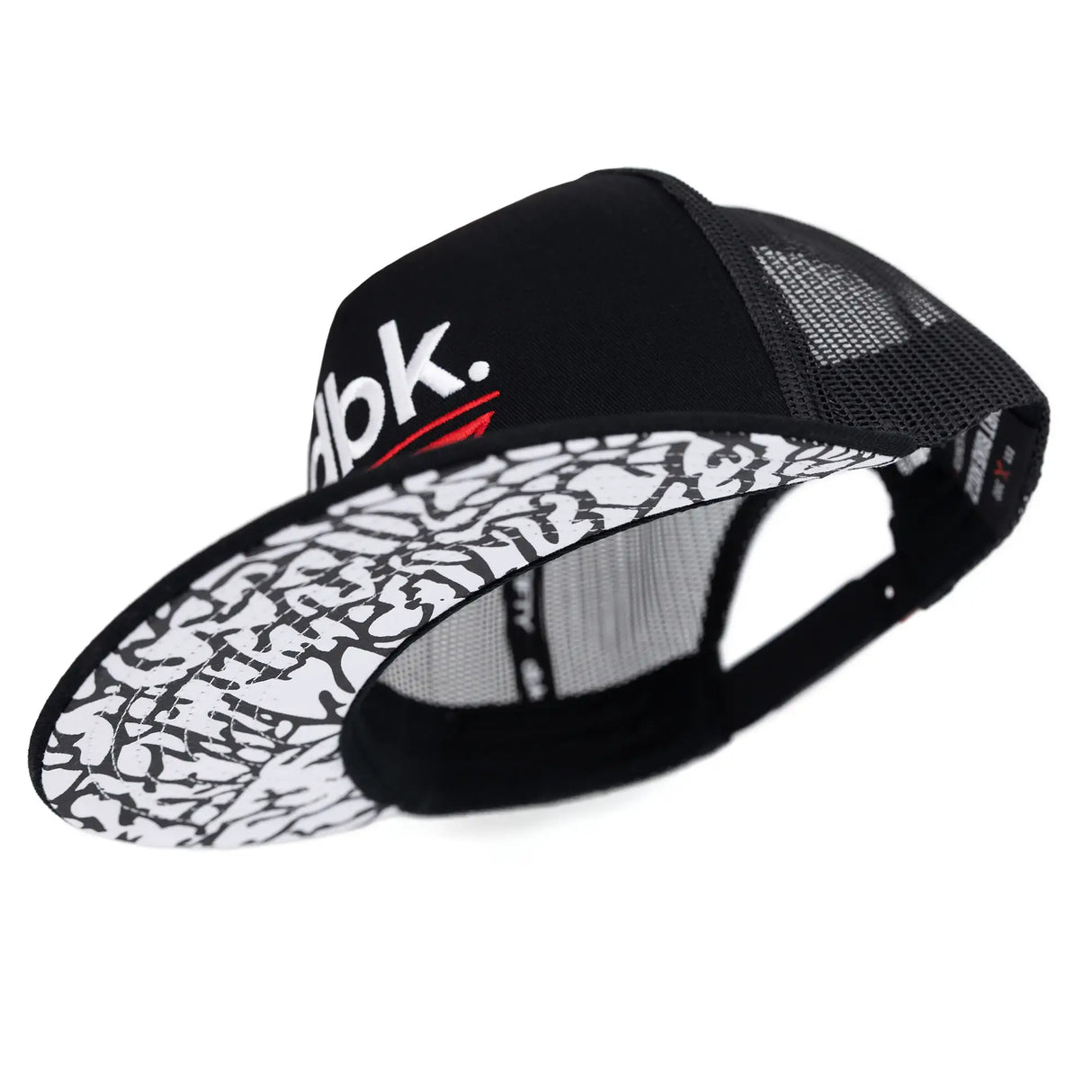 Black mesh trucker cap with patterned white-and-black underside brim panel