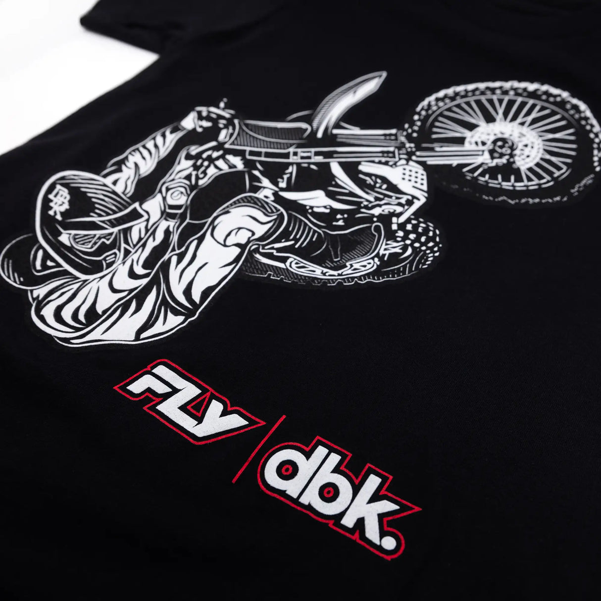 Black youth T-shirt close-up of white rider wheel graphic with red FLY dbk lettering