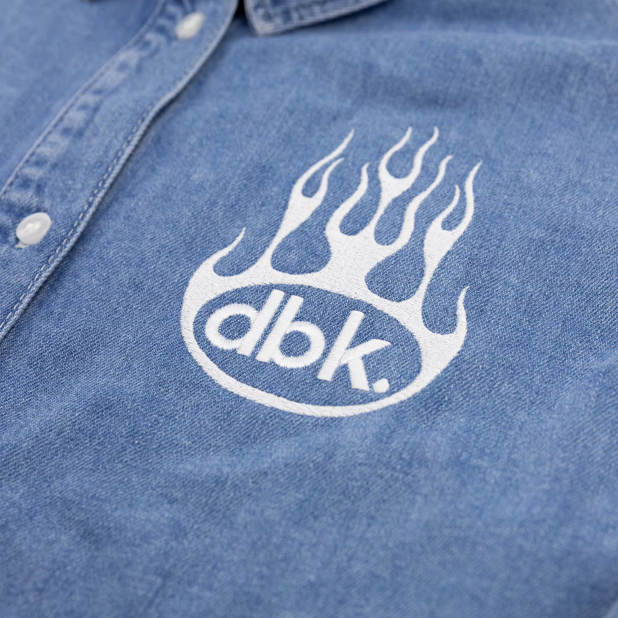 Burnout oversized denim shirt close-up of flame dbk logo print on chest