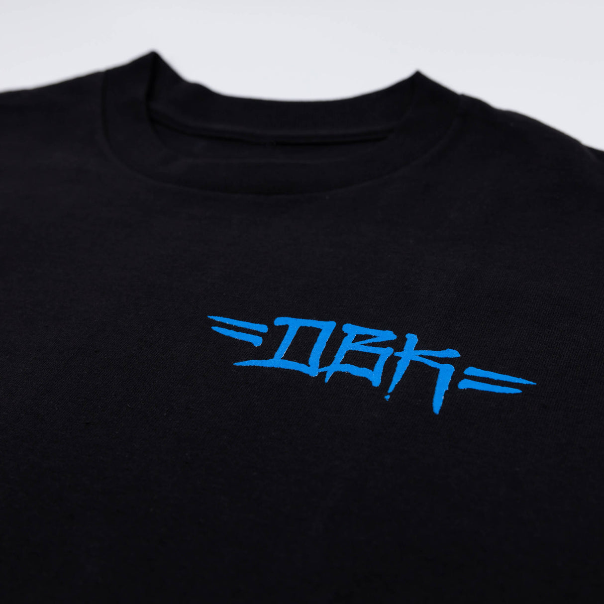Black T-shirt close-up with blue printed-style chest logo