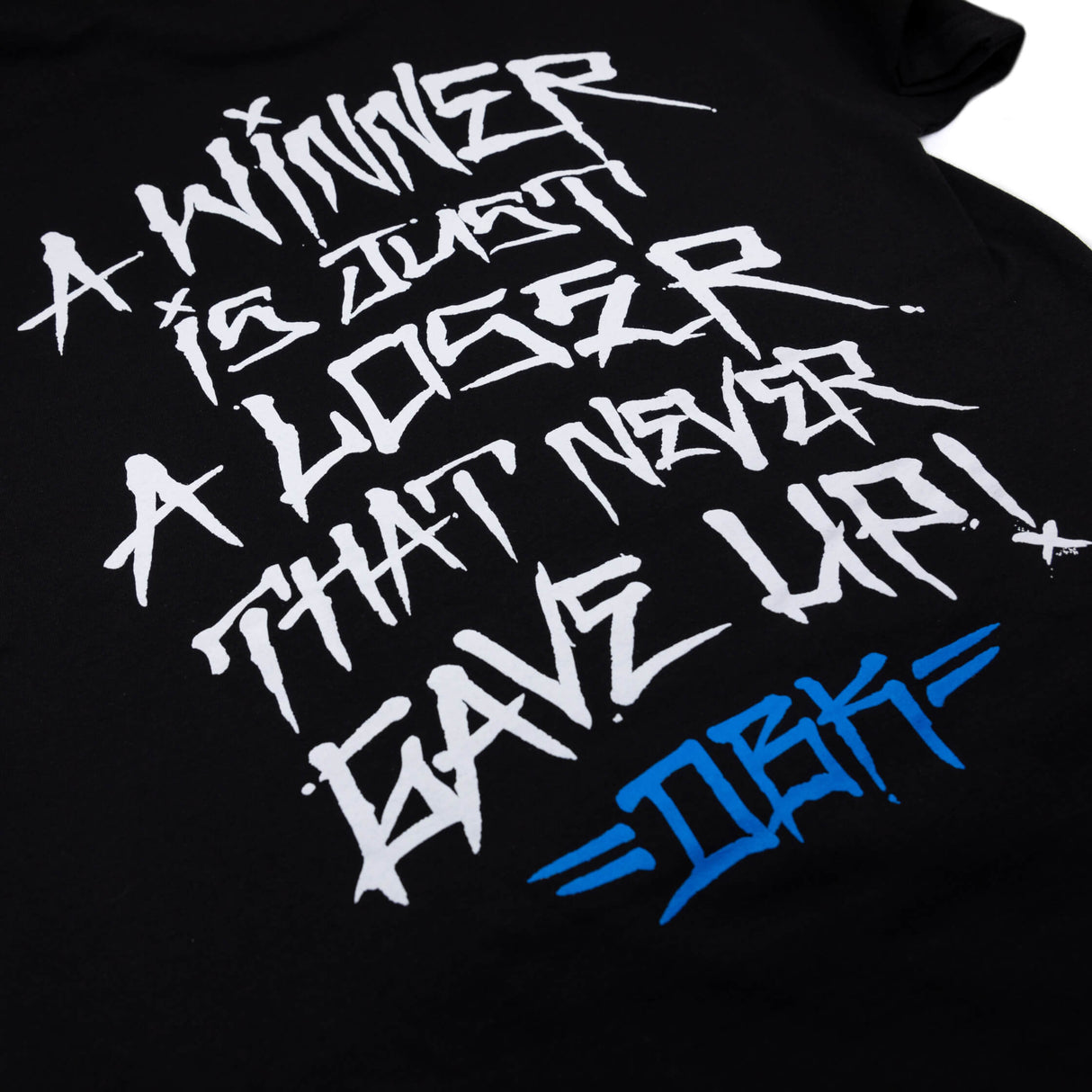 Black T-shirt close-up of white back graffiti text with blue logo accent