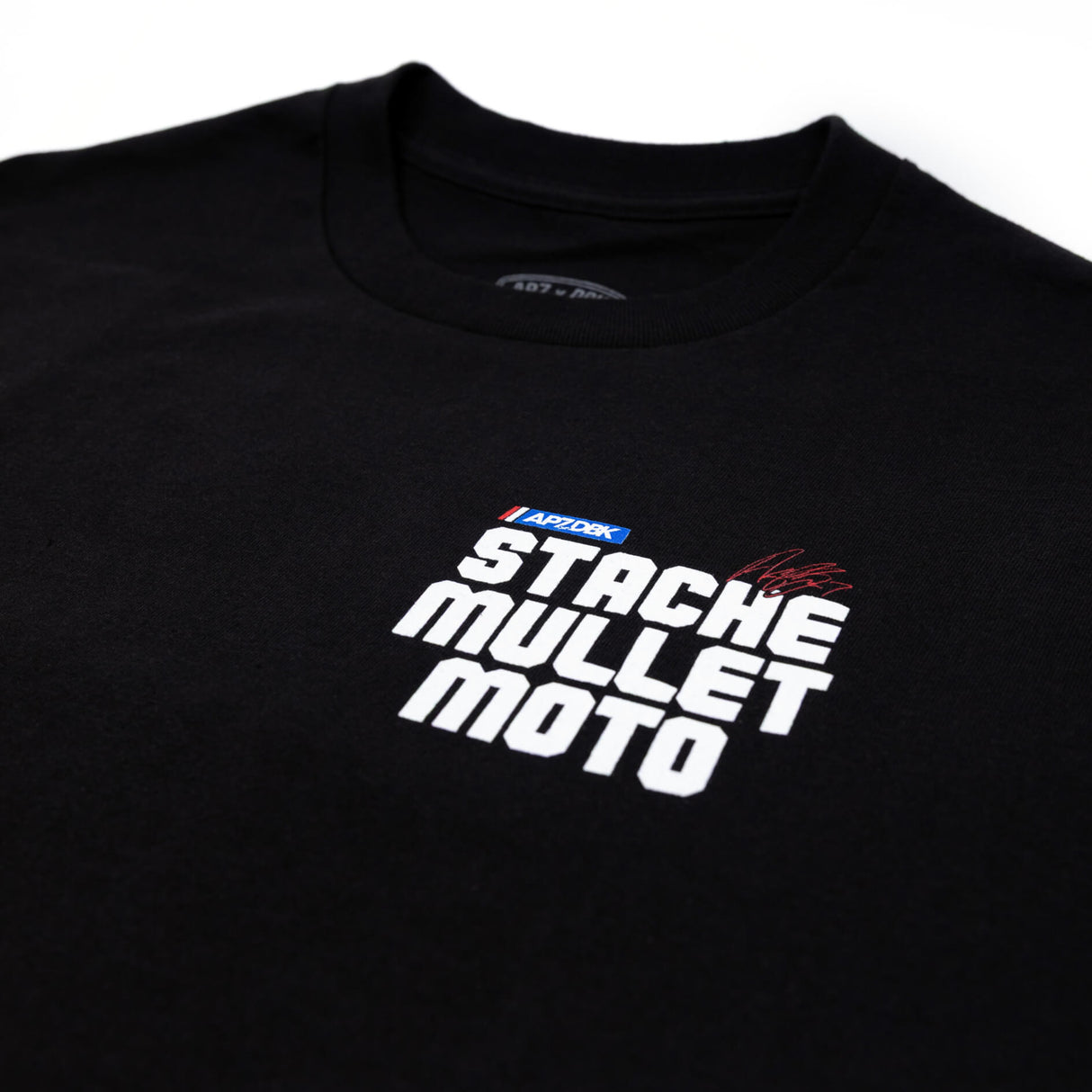 Black youth premium tee with “STACHE MULLET MOTO” graphic across the chest