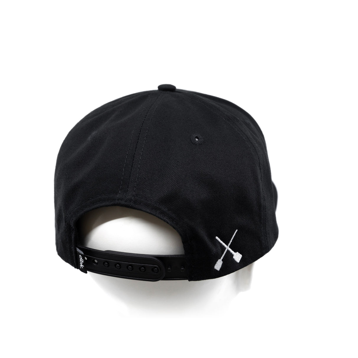 Black snapback cap with white X emblem on side and adjustable back strap
