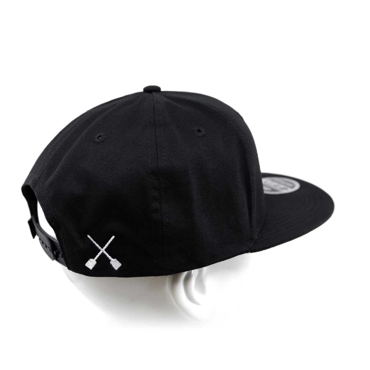 Black snapback cap with X logo on front side and adjustable back strap