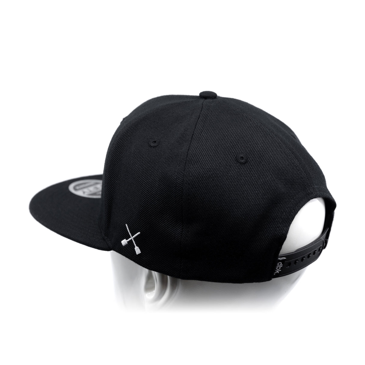Black baseball cap with white crossbones graphic and adjustable back strap