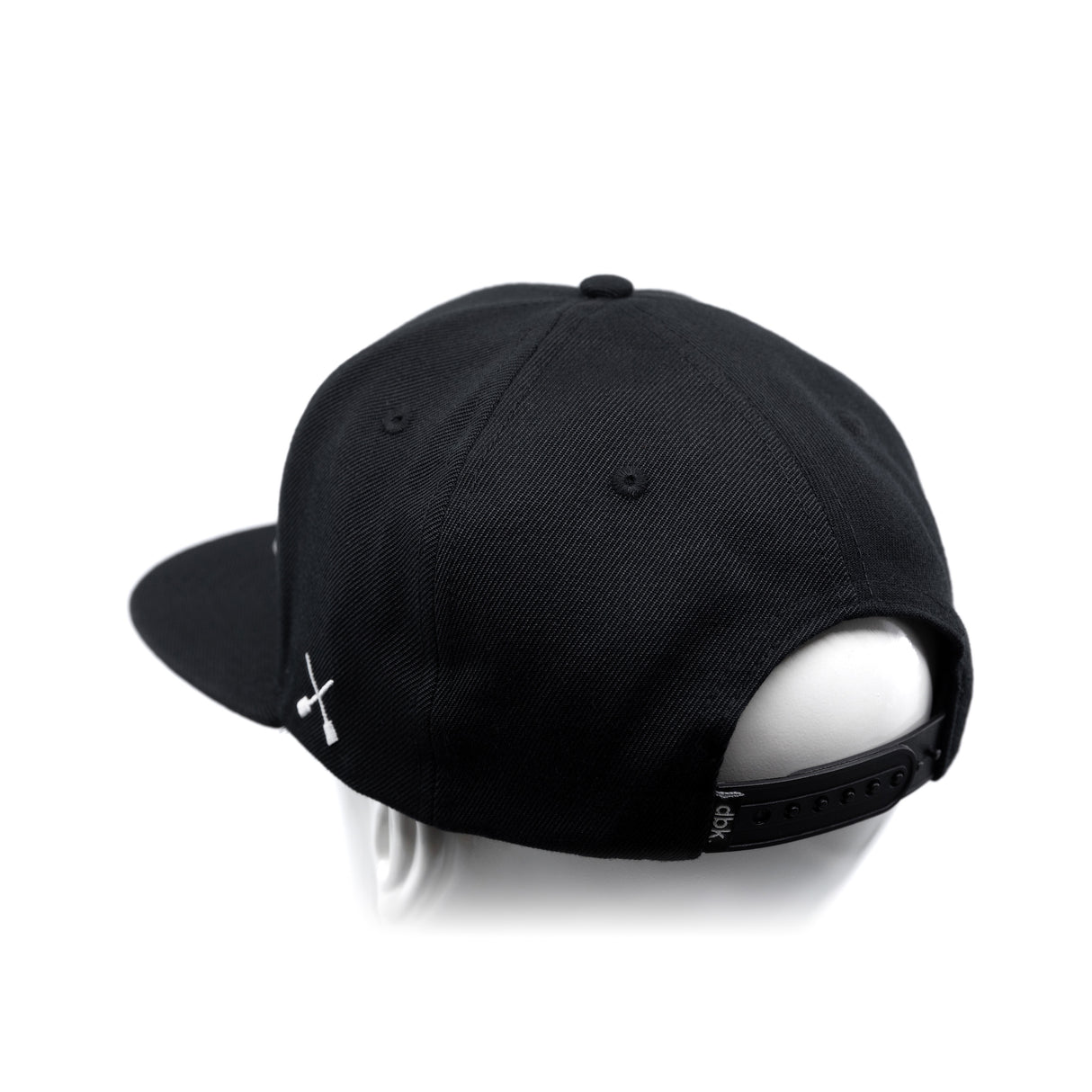 Black baseball cap with white crossbones logo and adjustable back strap detail