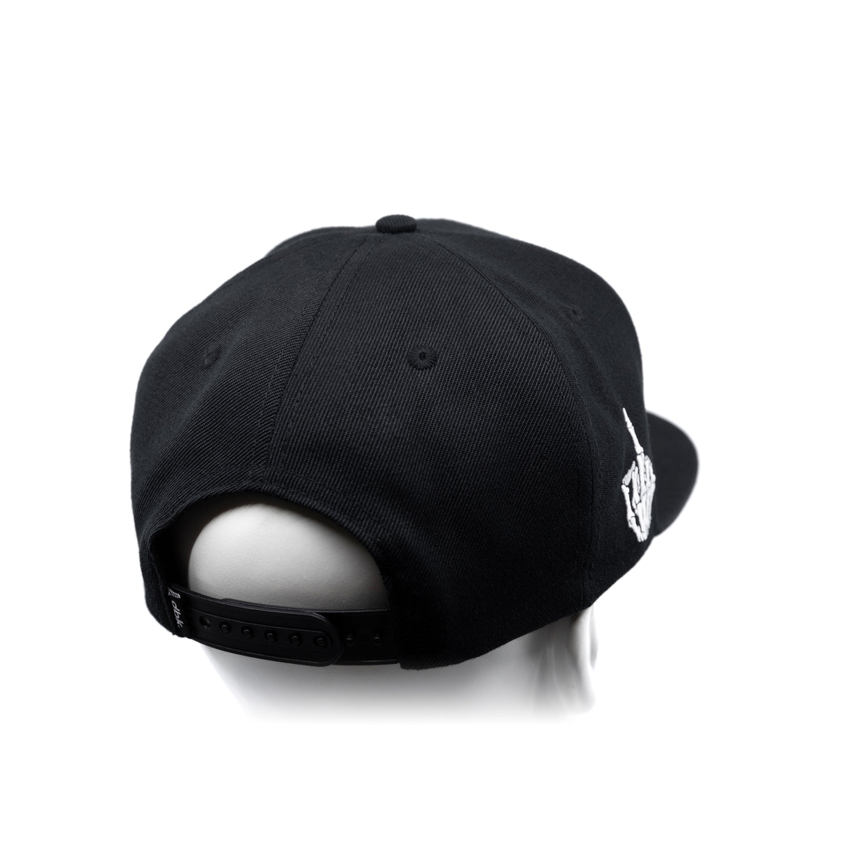 Black snapback cap with curved brim and white embroidered side graphic