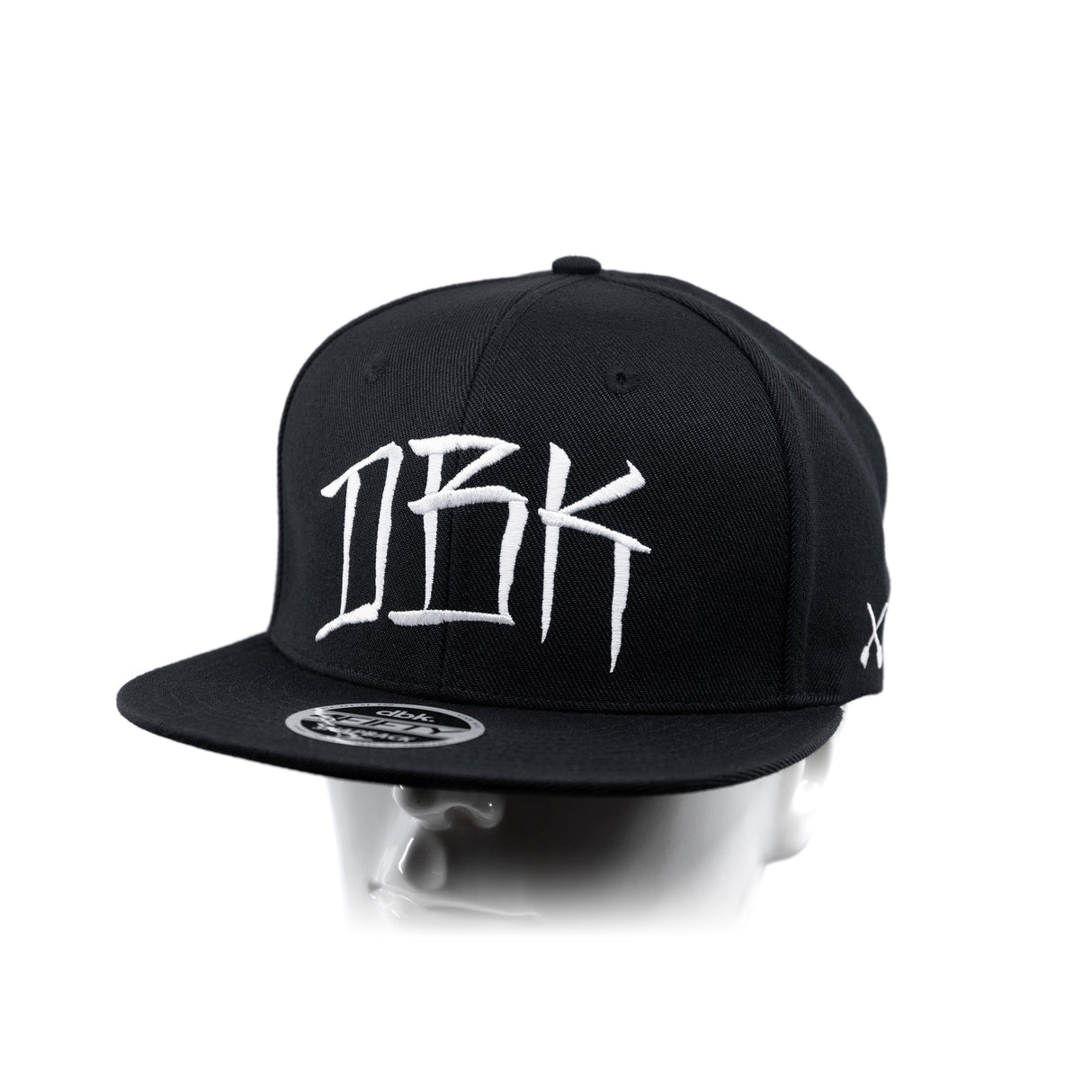 Black baseball cap with white graffiti-style 'DBK' graphic on the front panel