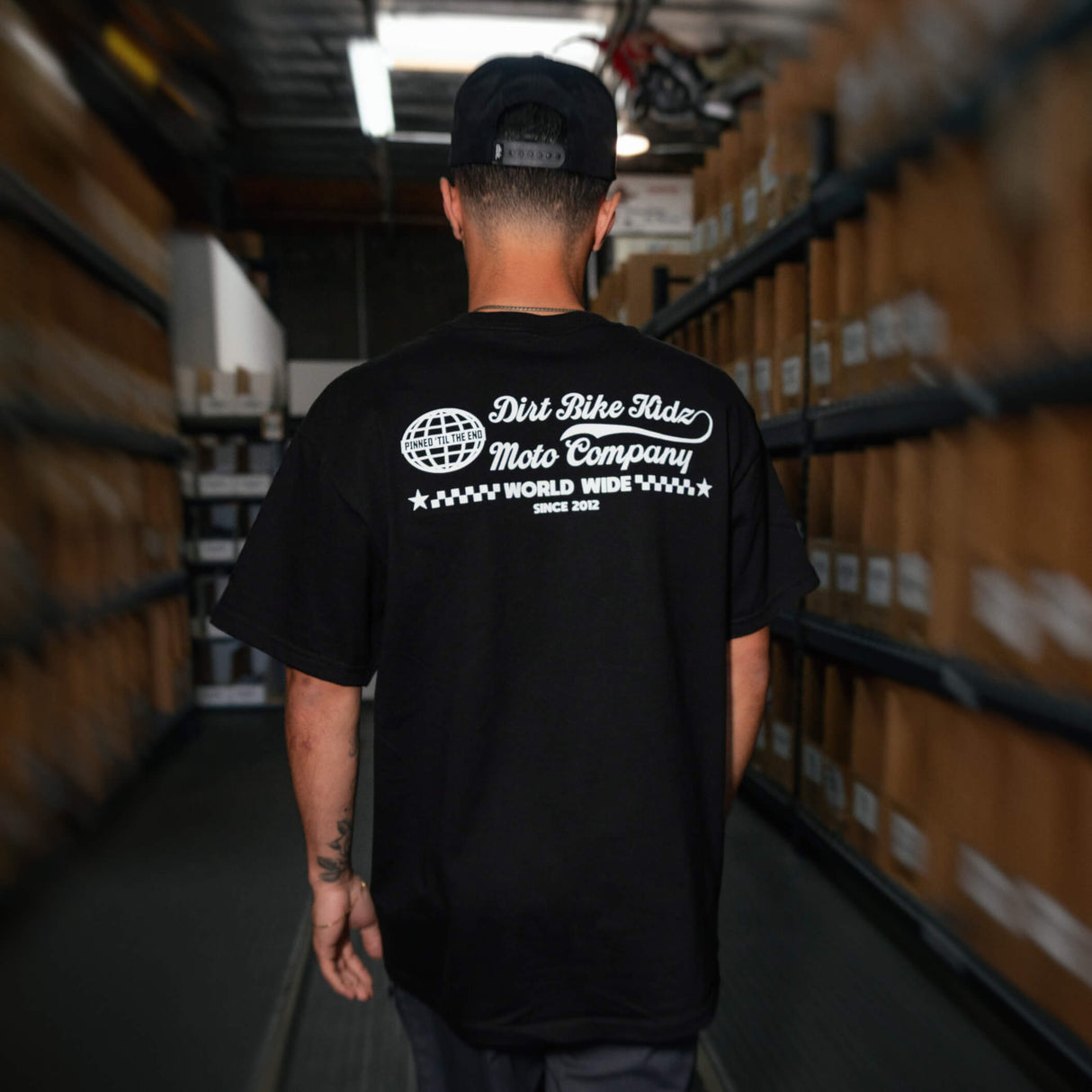 Black T-shirt with large white back graphic: Dirt Bike Kidz Moto Company, World Wide
