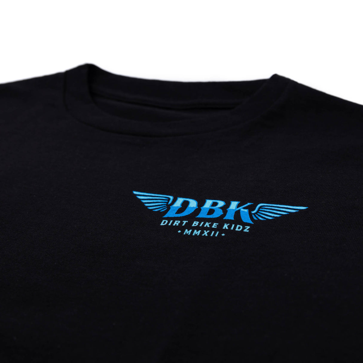 Close-up of black T-shirt chest graphic with blue DBK logo and tagline.