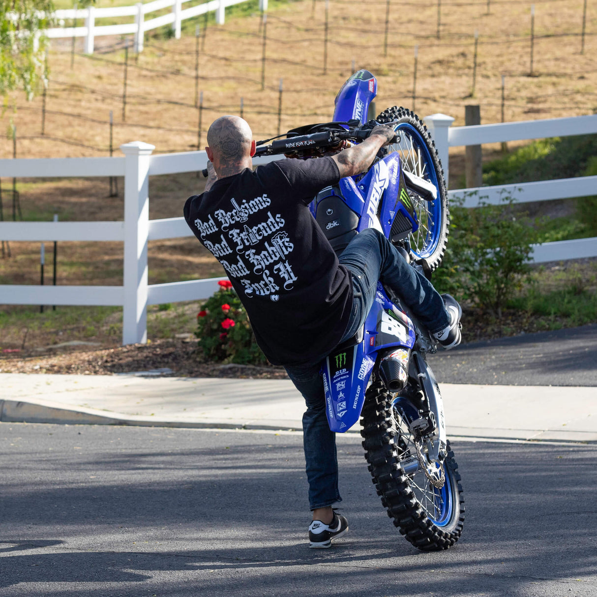 Black T-shirt on a rider with back text: Bad Decisions, Bad Friends, Bad Shits