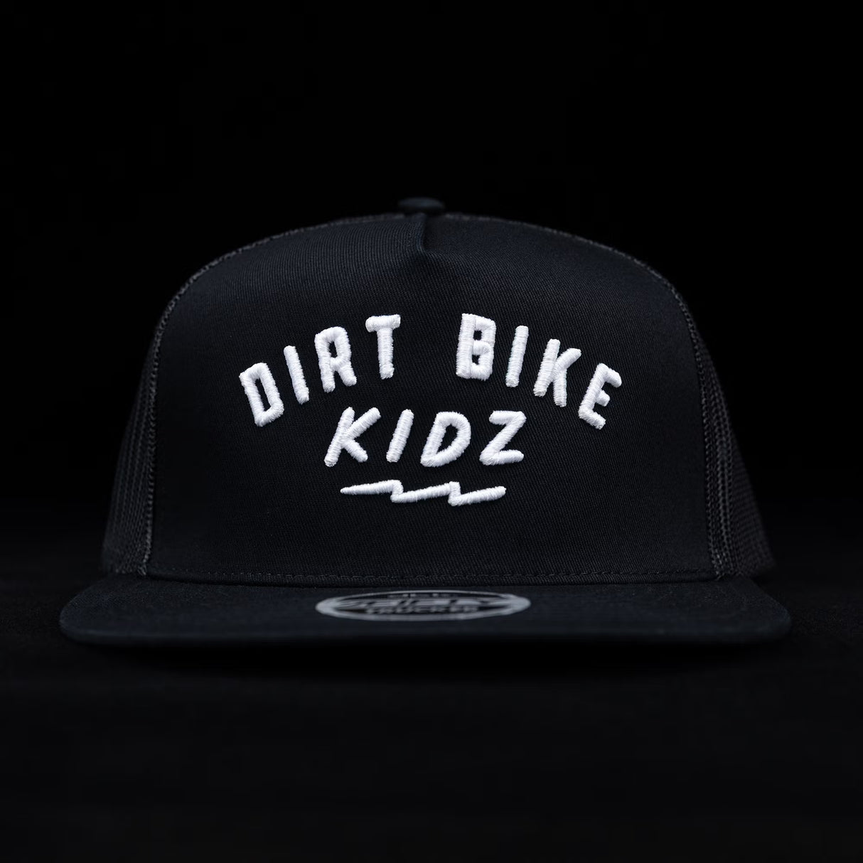 Black trucker cap with white 'DIRT BIKE KIDZ' front graphic and flat brim