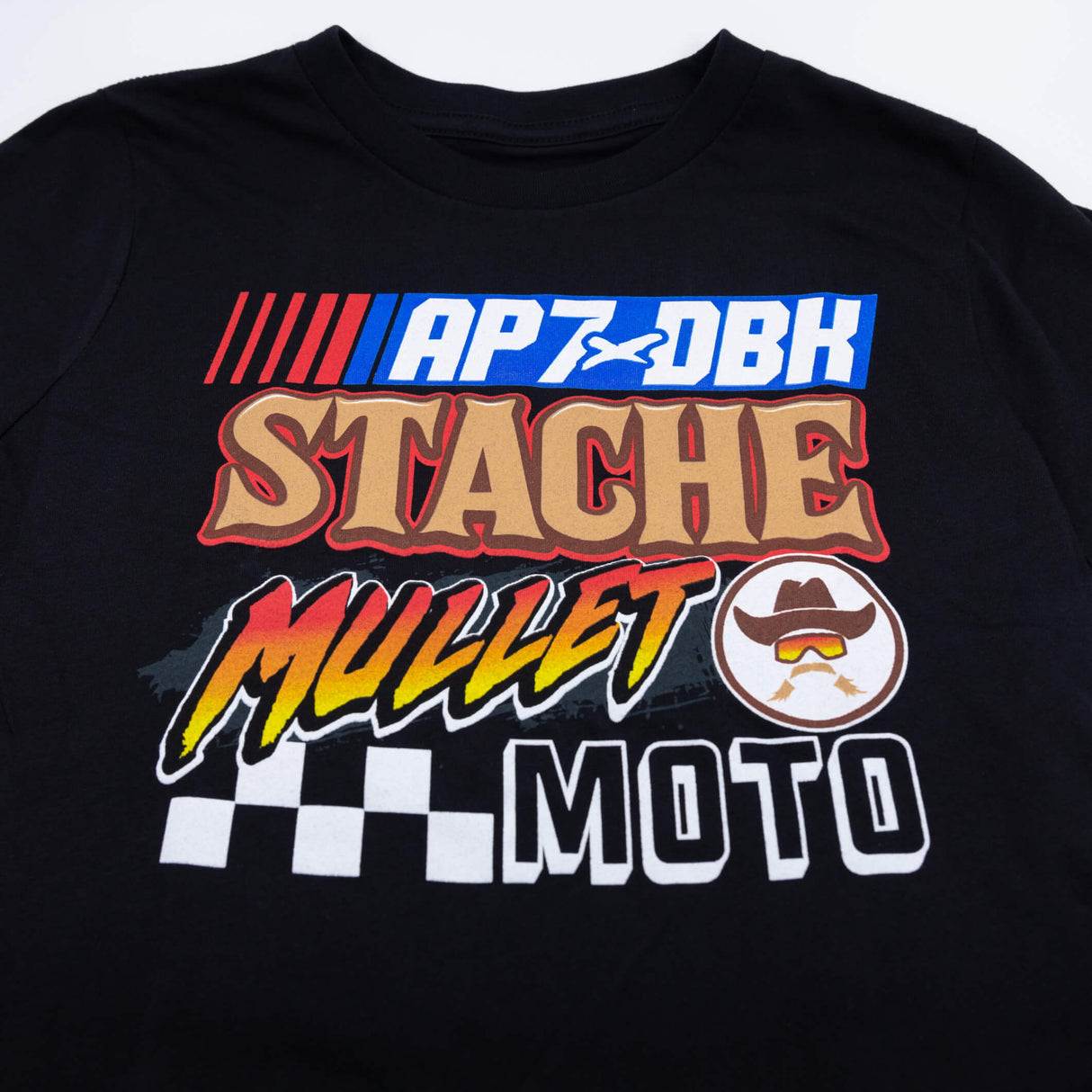 Youth T-shirt in black with 'AP7-DBK' and 'Stache Mullet Moto' front graphic