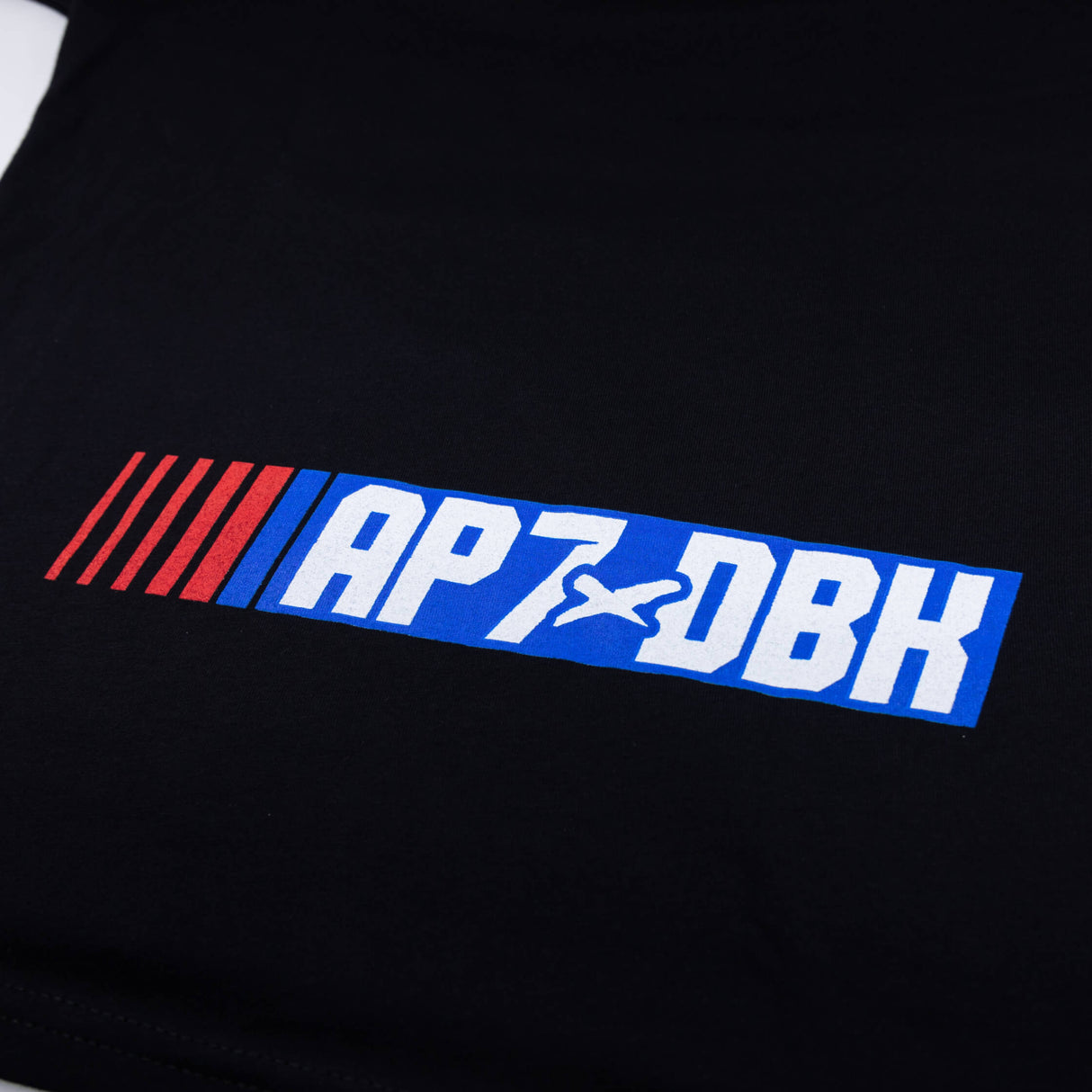 Youth T-shirt in black with 'AP7-DBK' logo graphic stripe on the chest