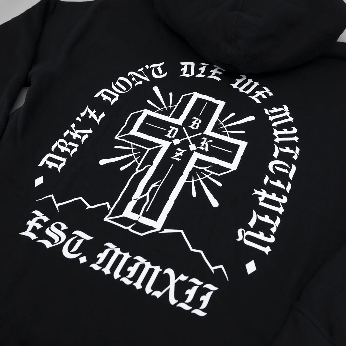 Black zip hoodie with large back cross emblem graphic in white and gray tones.