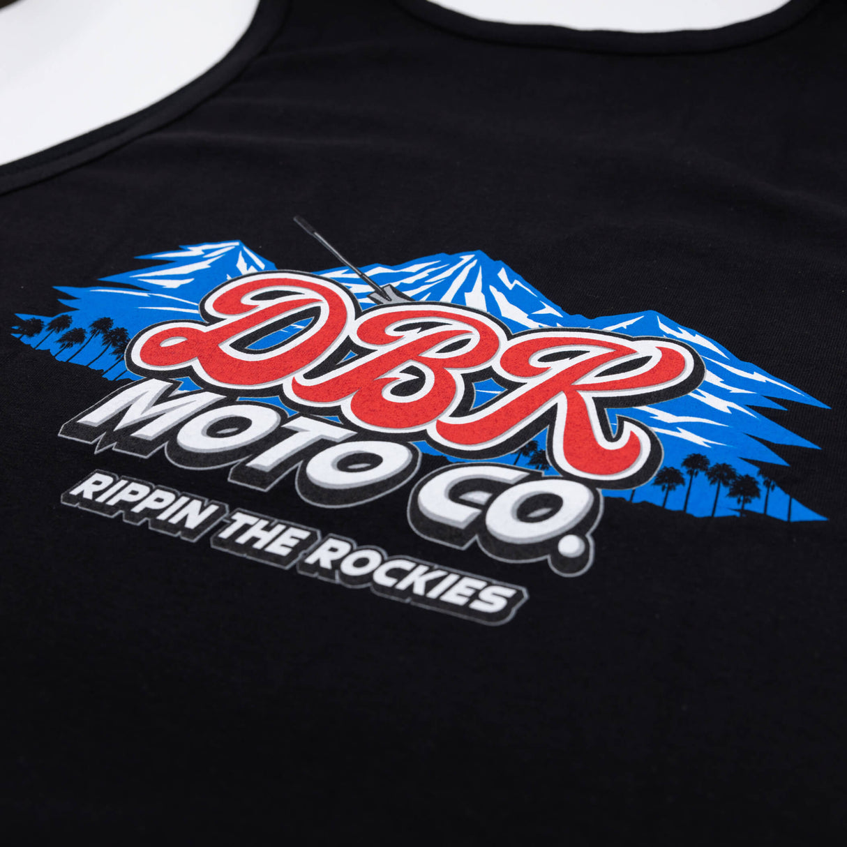Black tank top with DBR Moto Co graphic of mountains and “Rippin the Rockies”.