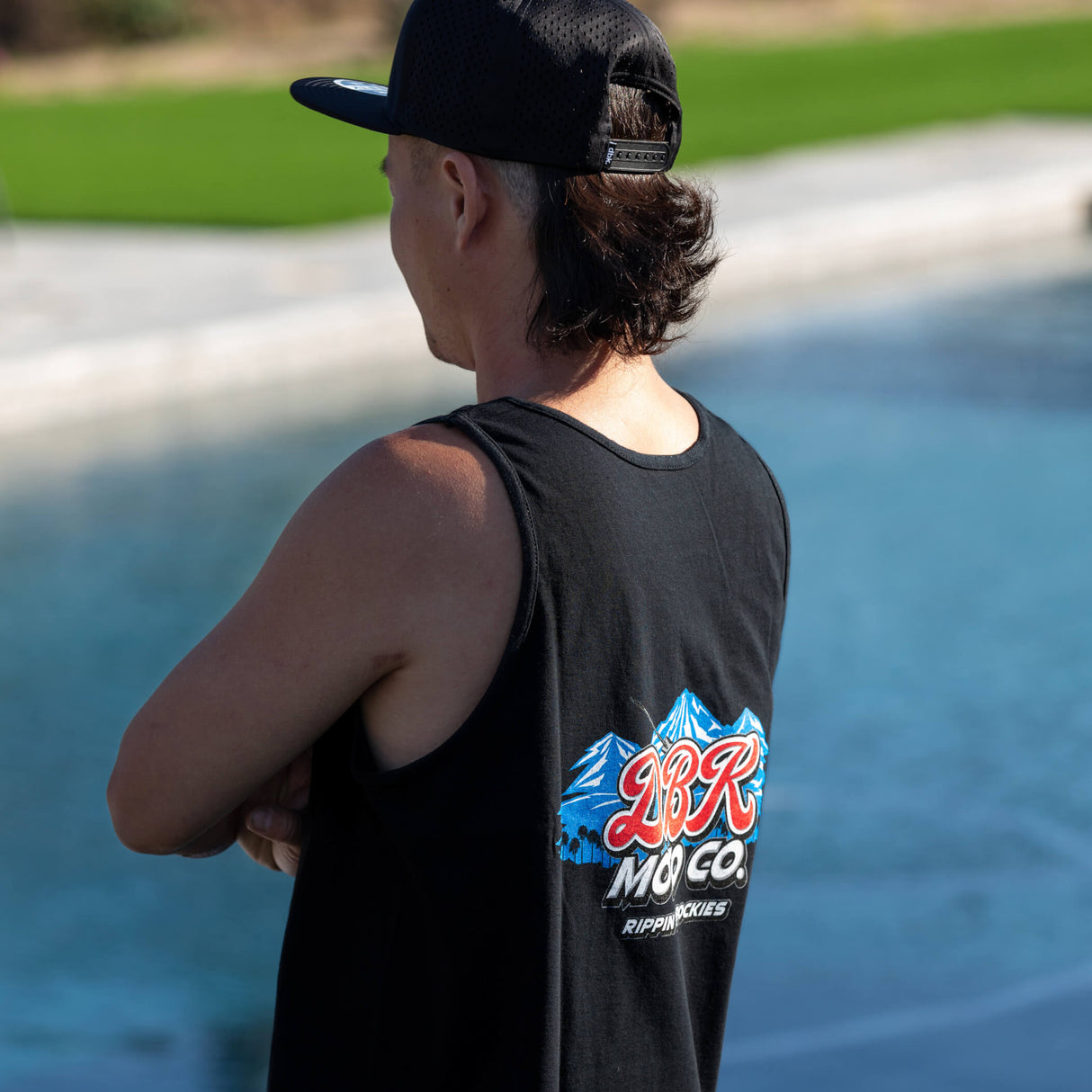 Black tank top worn from side, showing DBR Moto Co logo on back.