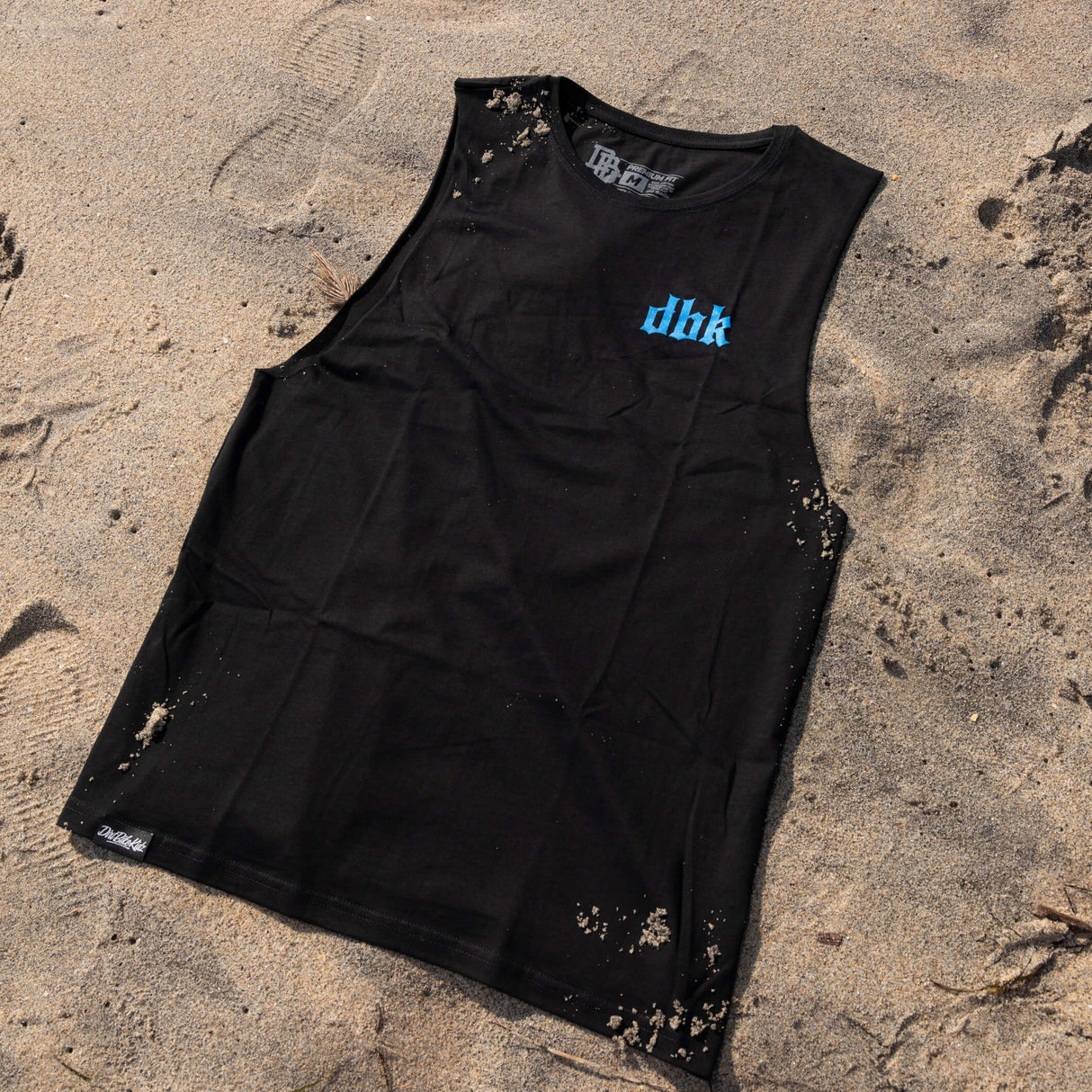 Black tank top with blue dbk logo and speckled fabric spots