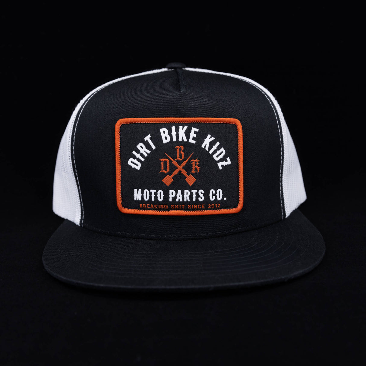 Black and white mesh trucker hat with orange logo patch front.