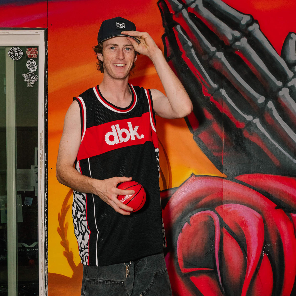 Black and red jersey tank with dbk logo, sleeveless cut, and white-red trim.