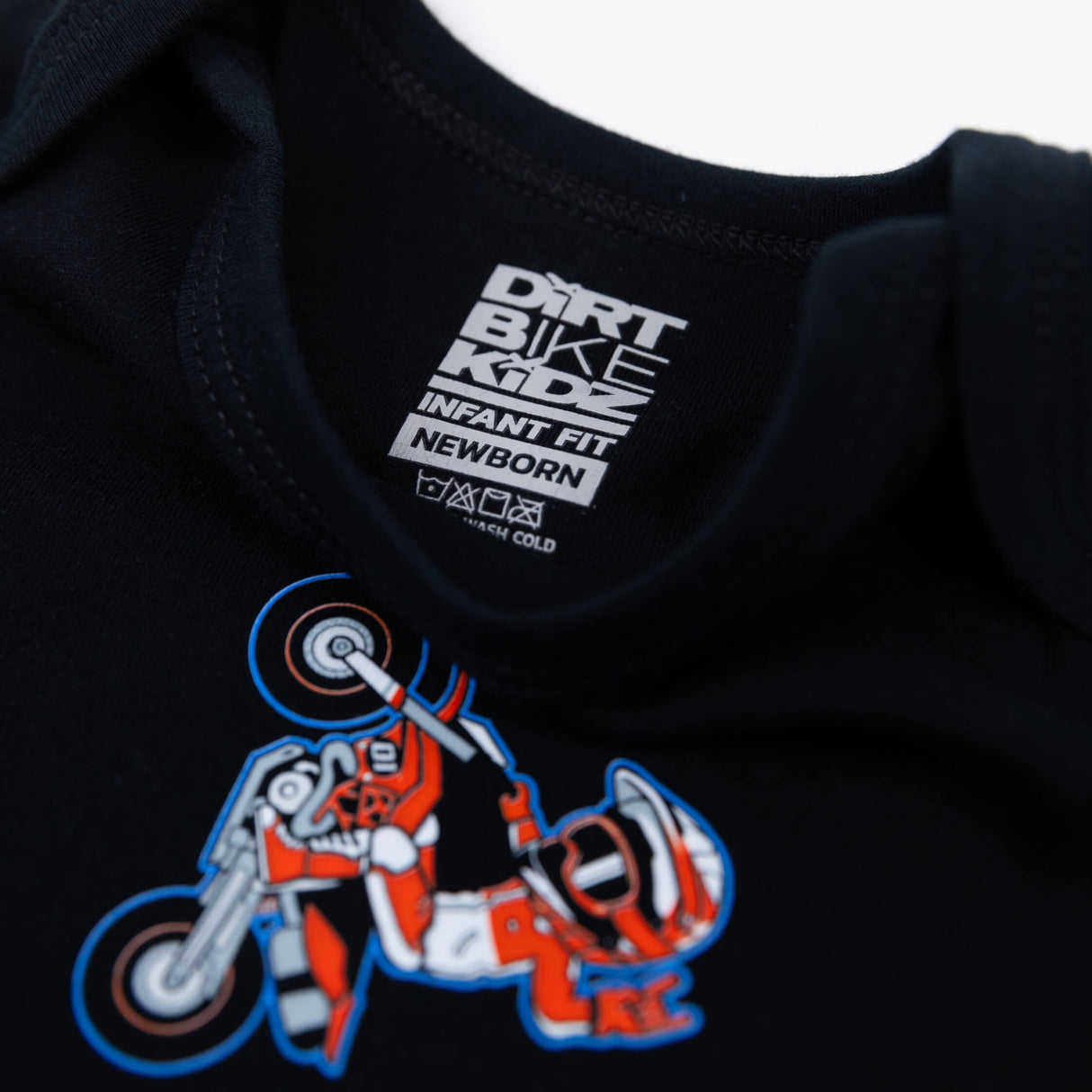 Black baby onesie neckline with DIRT BIKE infant fit newborn label and rider graphic
