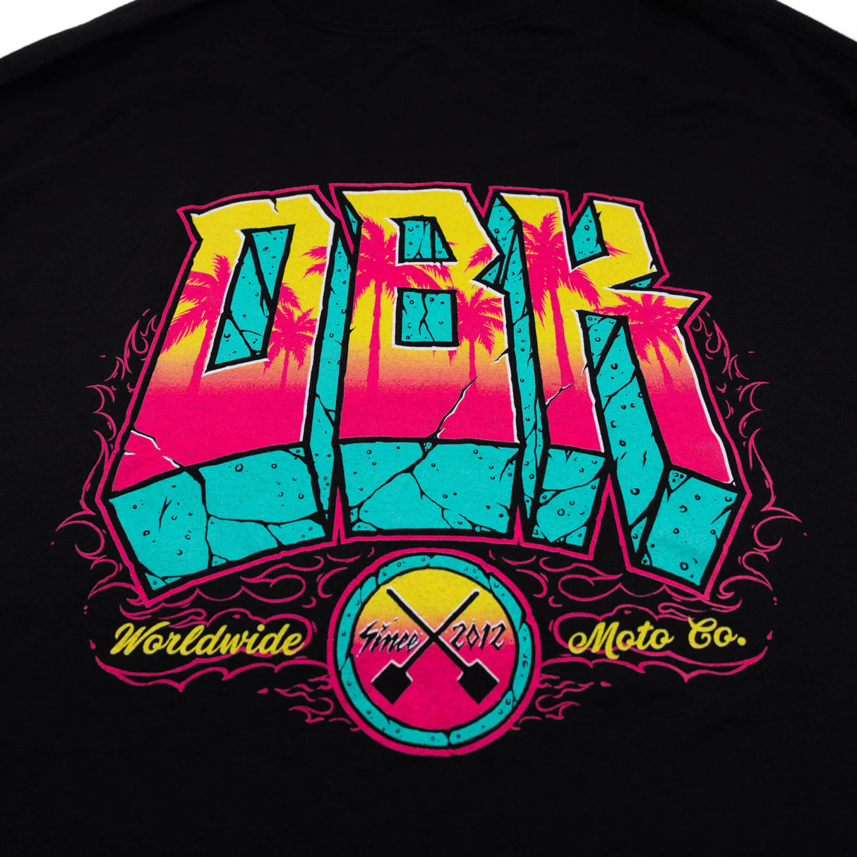 Black crewneck tee with multicolor DBK full front graphic and badges