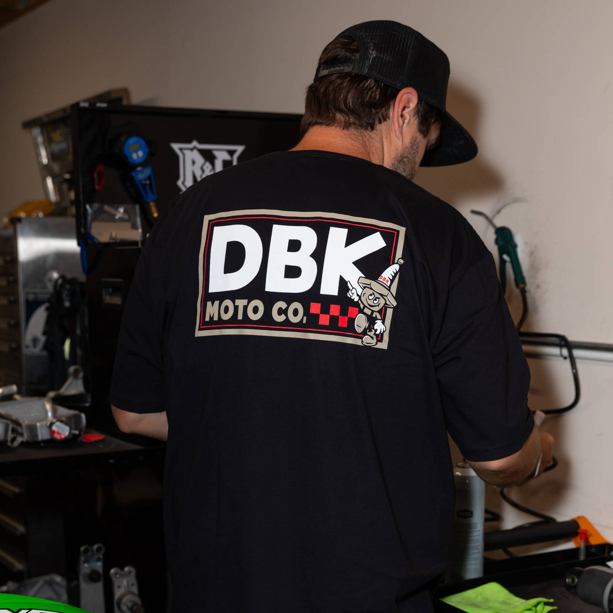 Black T-shirt worn, back view with DBK Moto Co. rectangular logo graphic.