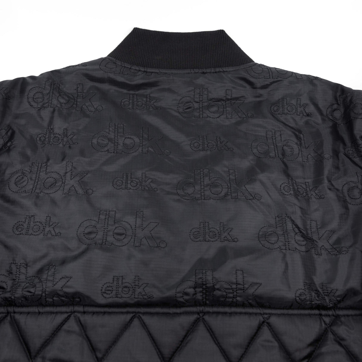 Premium jacket back with repeating dbk logo print and quilted diamond paneling