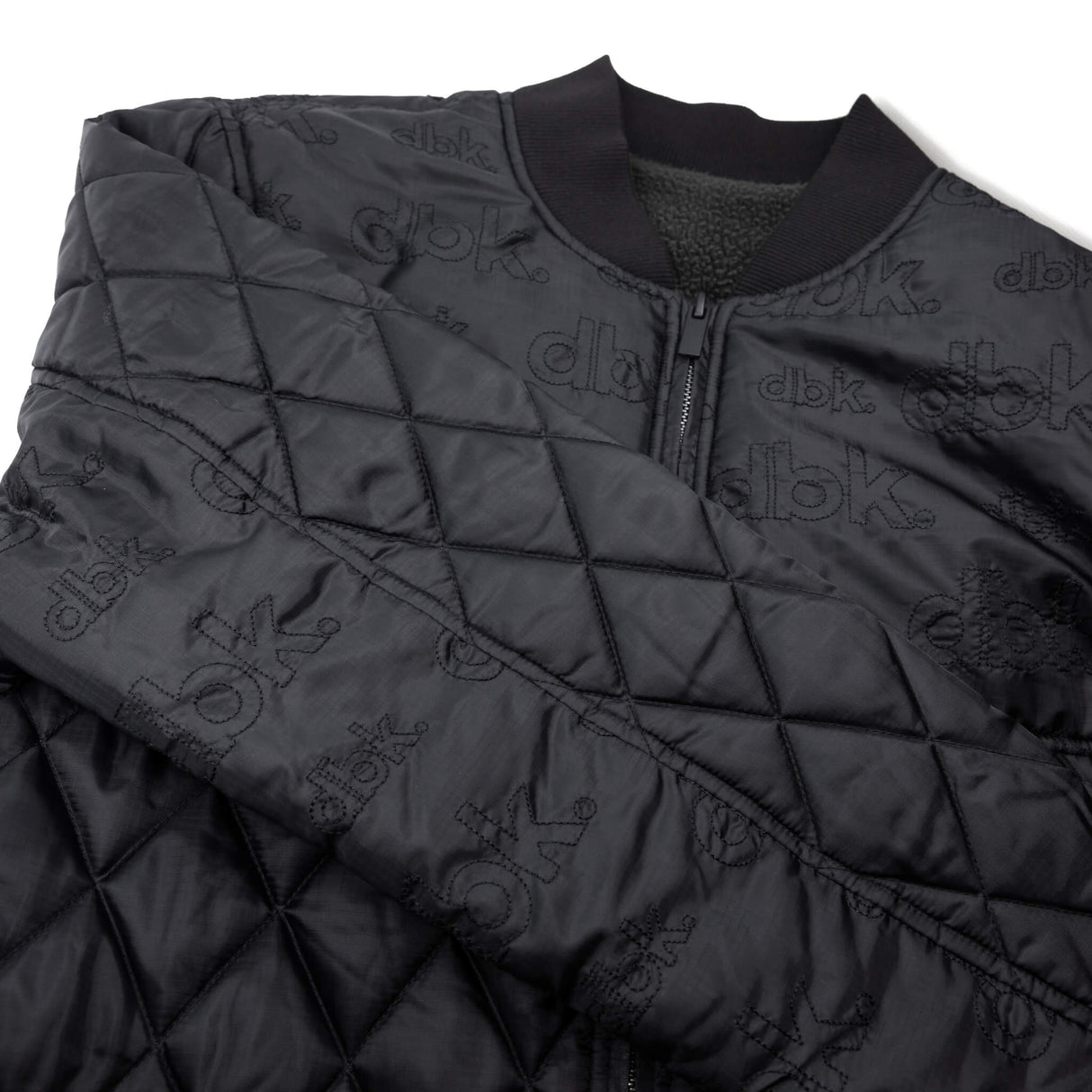 Premium quilted jacket with full-zip front, ribbed collar, and repeating dbk logo print