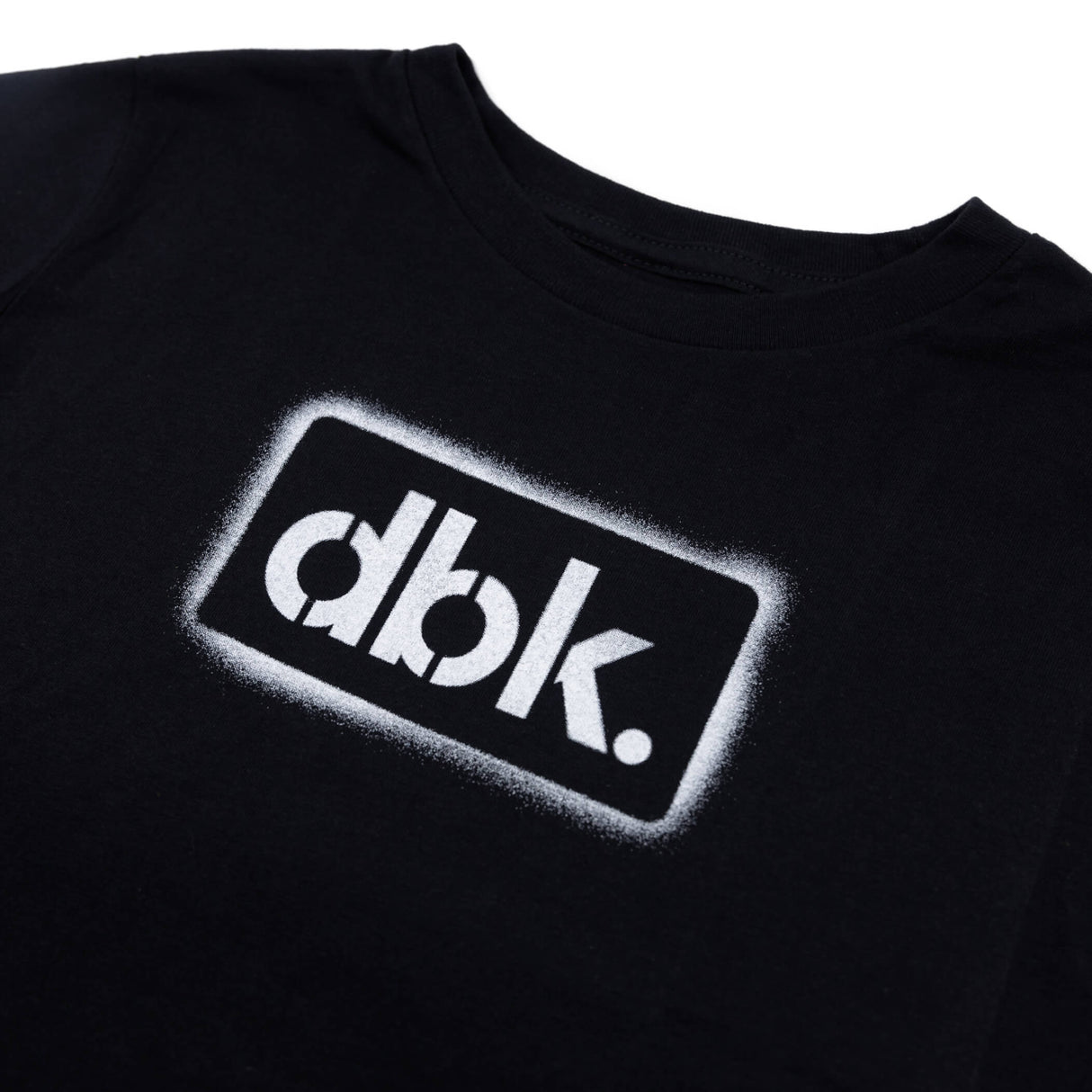 Youth black T-shirt close-up of dbk. logo patch print