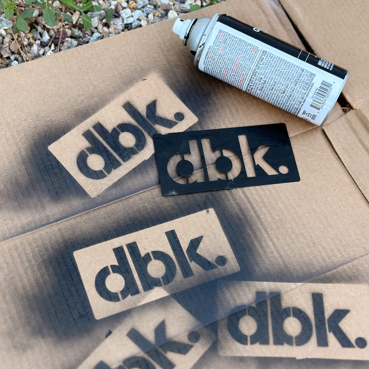 T-shirt stencil set with dbk. logo cutouts on cardboard