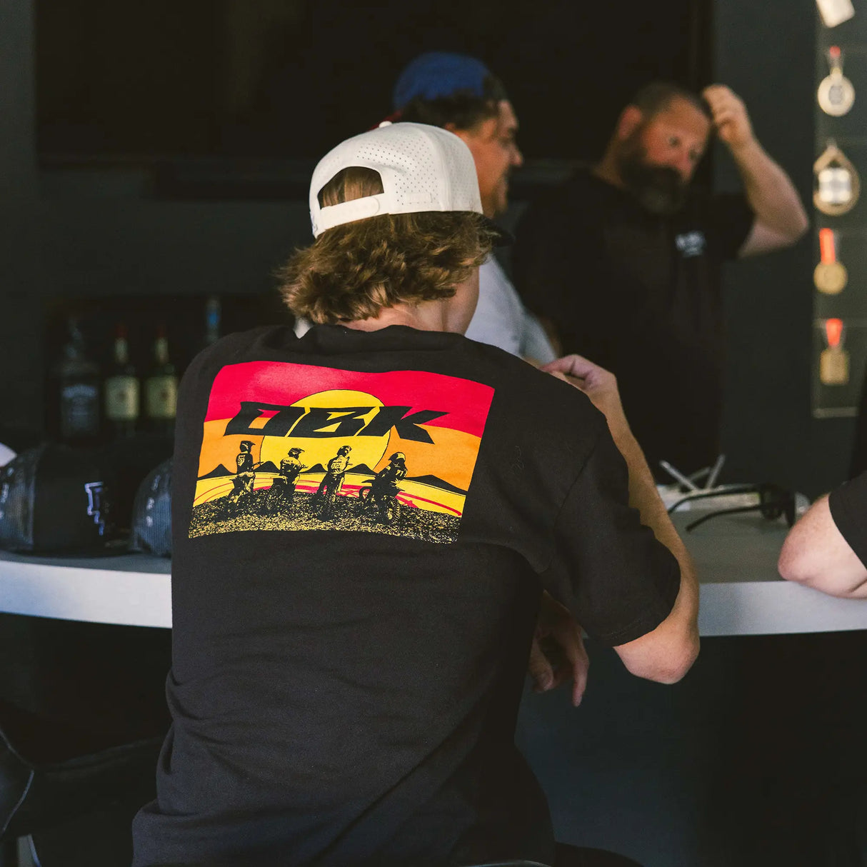 Black tee with large colorful graphic print on the back and crew neck
