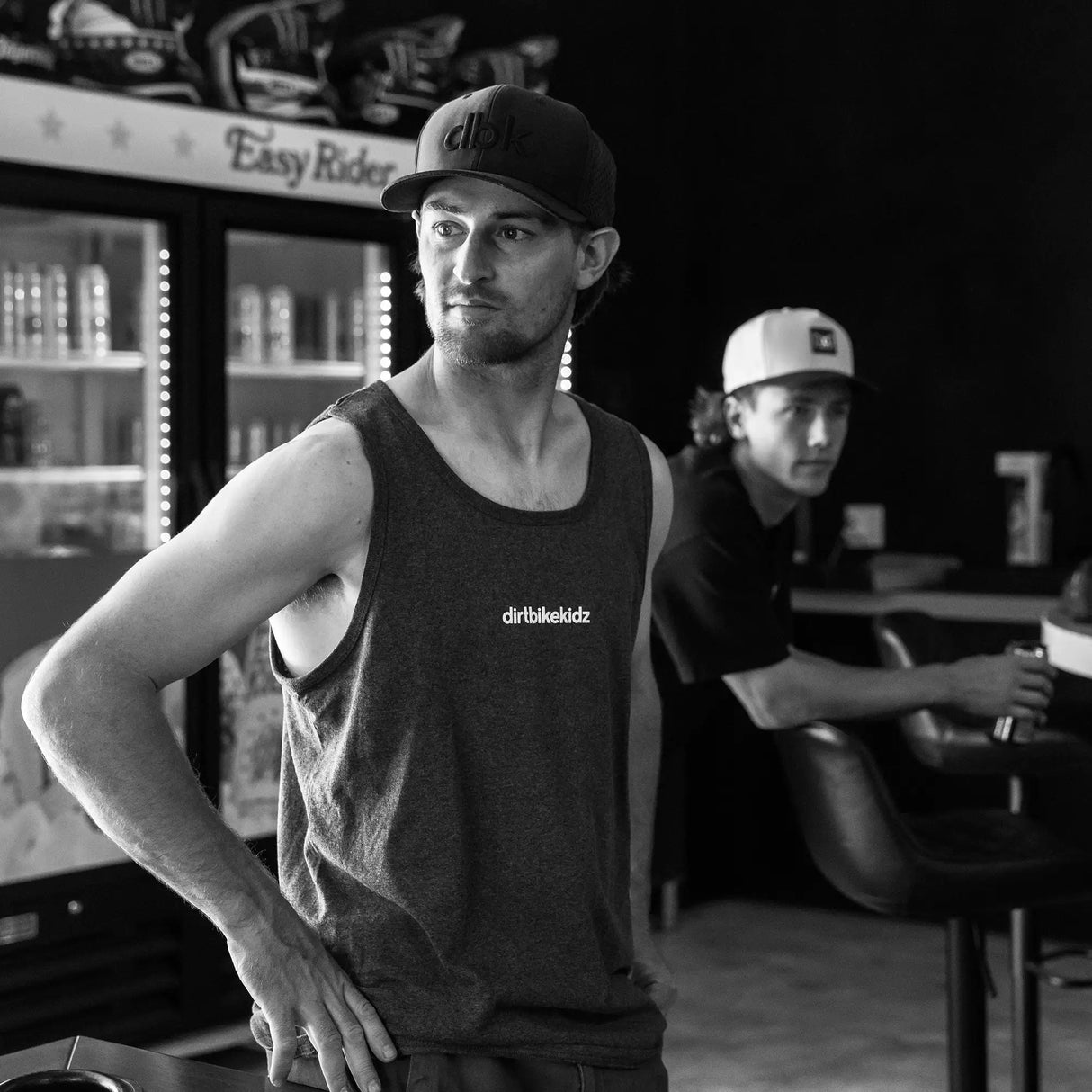 Dark gray sleeveless tank top with 'dirtbikekidz' chest logo, casual fit.