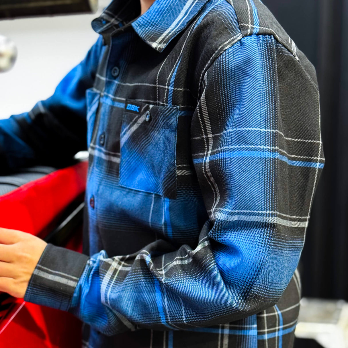 Youth flannel shirt with blue and black plaid, button front and chest pocket