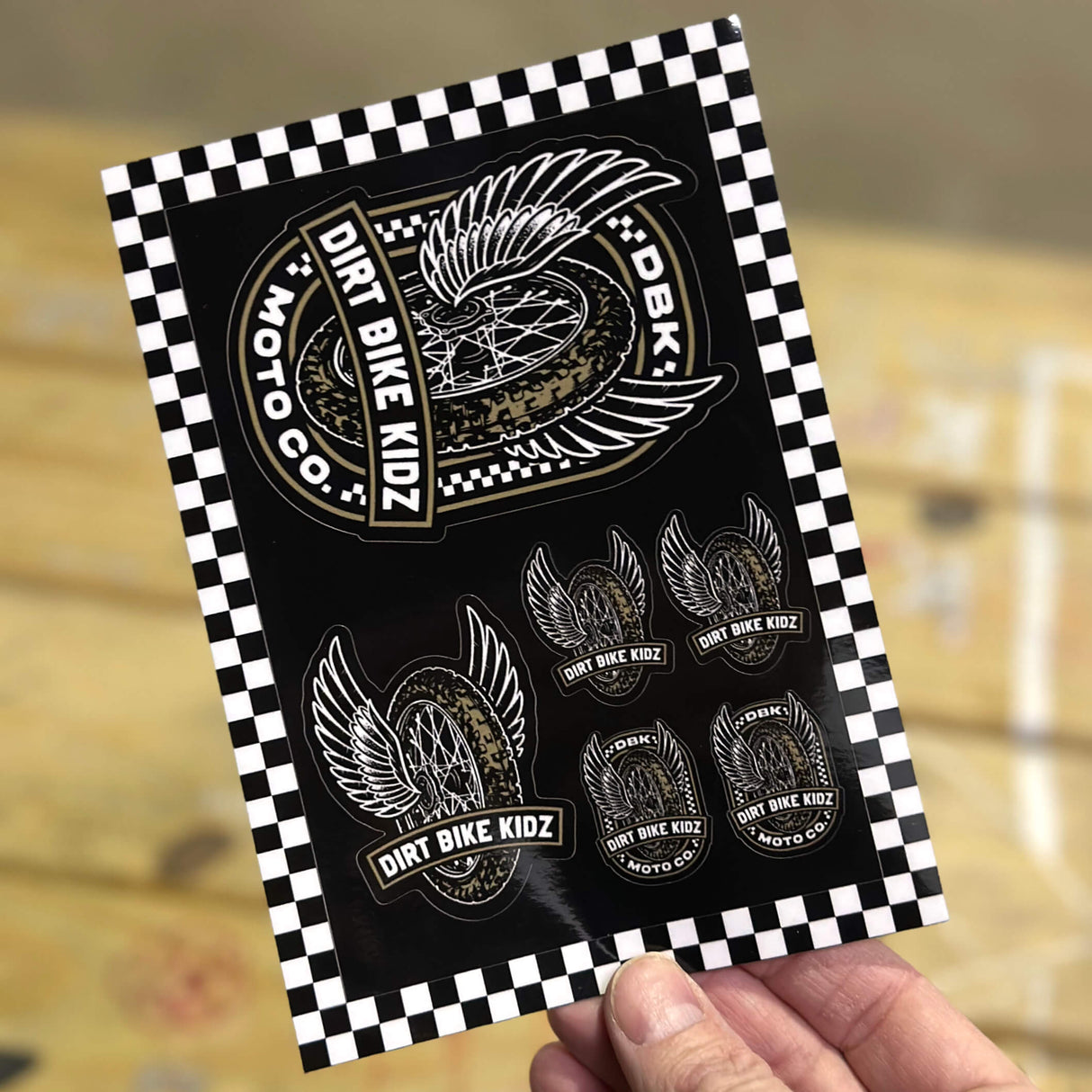 Sticker pack sheet with multiple winged dirt bike stickers, DIRT BIKE KIDZ text on black