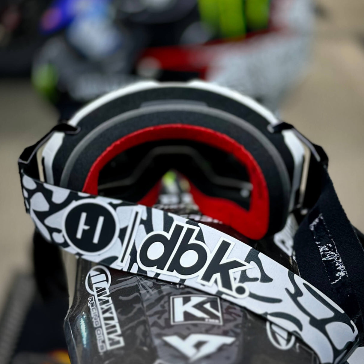 Helios goggle close-up with red inner foam and black-and-white graphic strap
