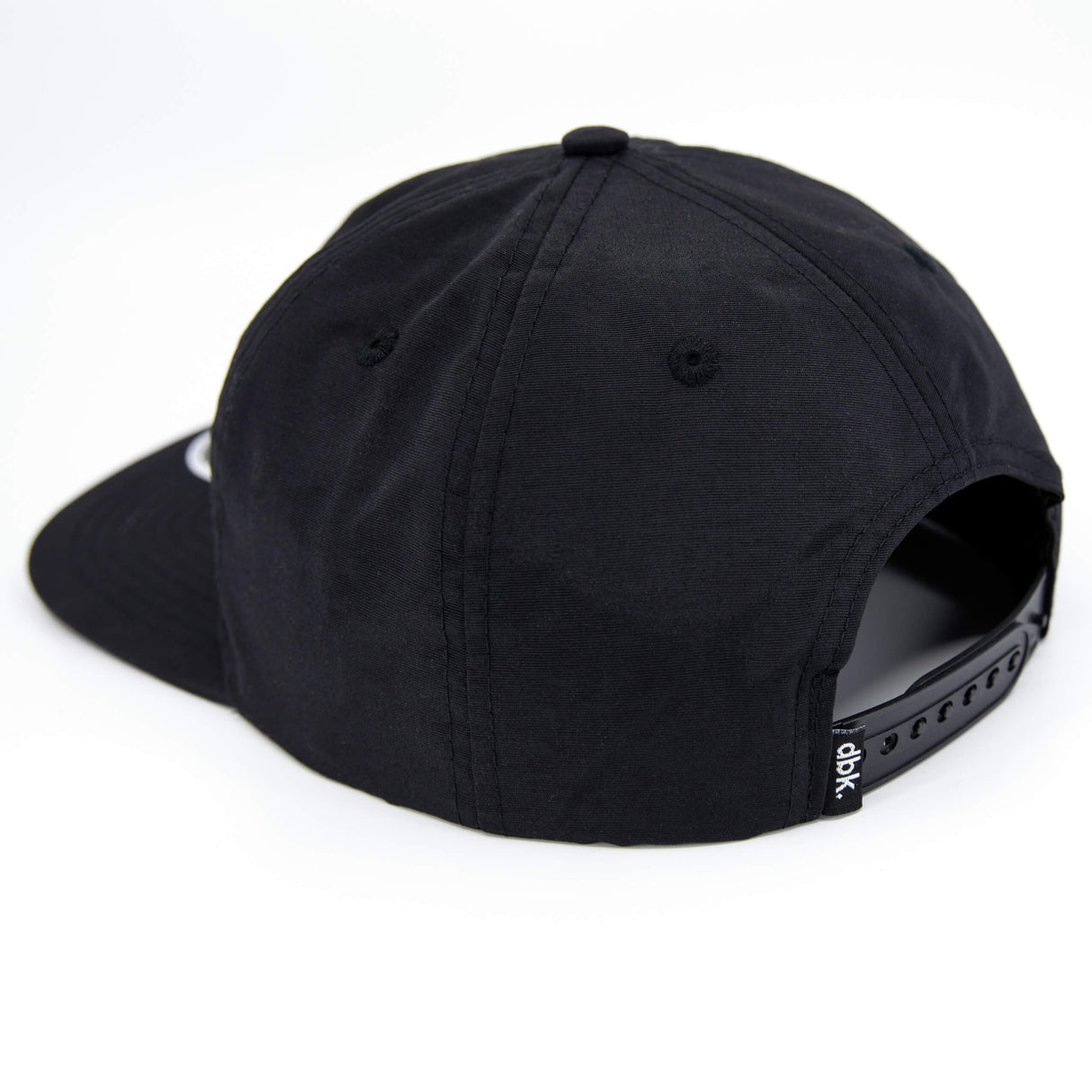 Black snapback cap back view with ventilation eyelets and side strap detail.