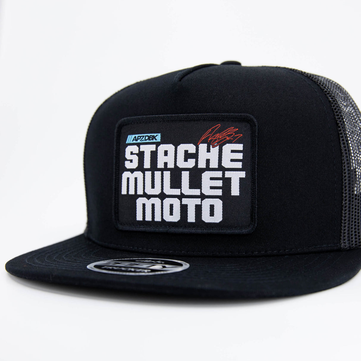 Black trucker cap with front logo patch, curved brim, and mesh back panels.