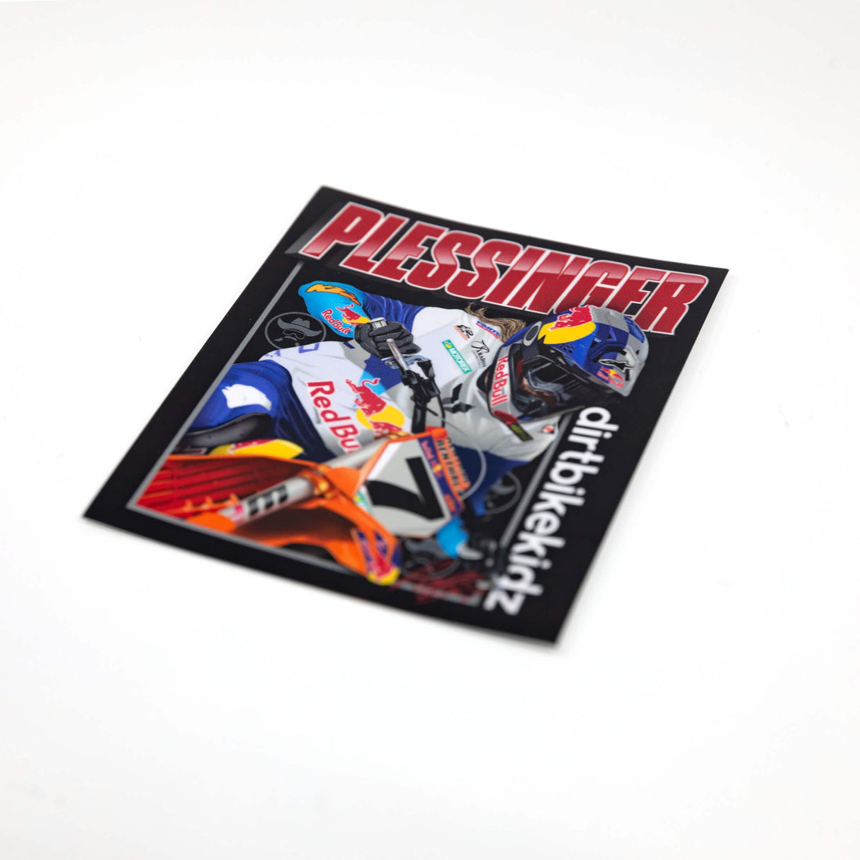 Motorcycle sticker close-up showing rider artwork, orange bike, blue helmet, PLESSINGFER